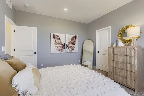 a bedroom with a bed and a dresser