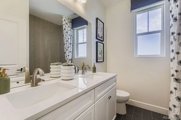 a bathroom with a sink toilet and mirror