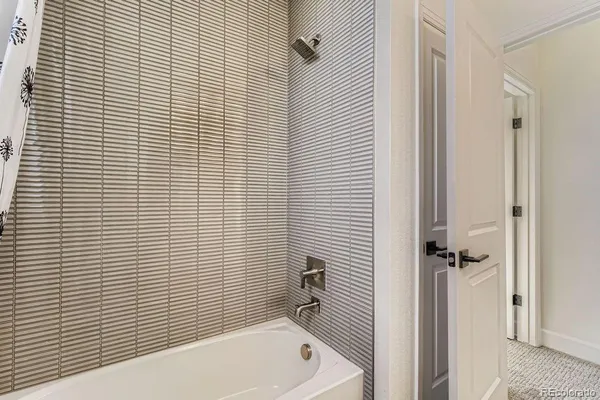 a bathroom with a tub and shower