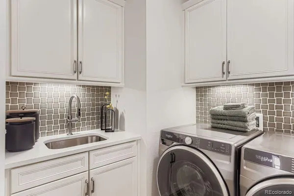 a kitchen with a sink and a stove top oven