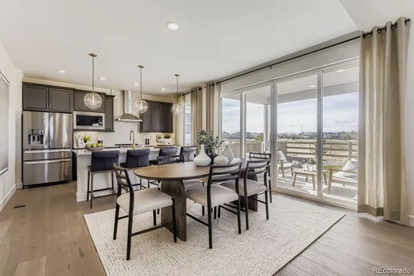 a kitchen with kitchen island a large window and stainless steel appliances