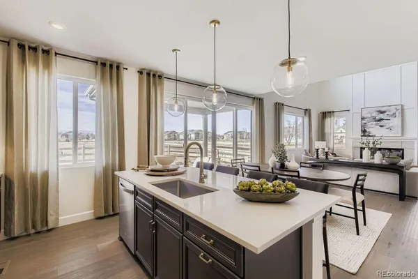 a kitchen with stainless steel appliances granite countertop a sink a stove and a refrigerator