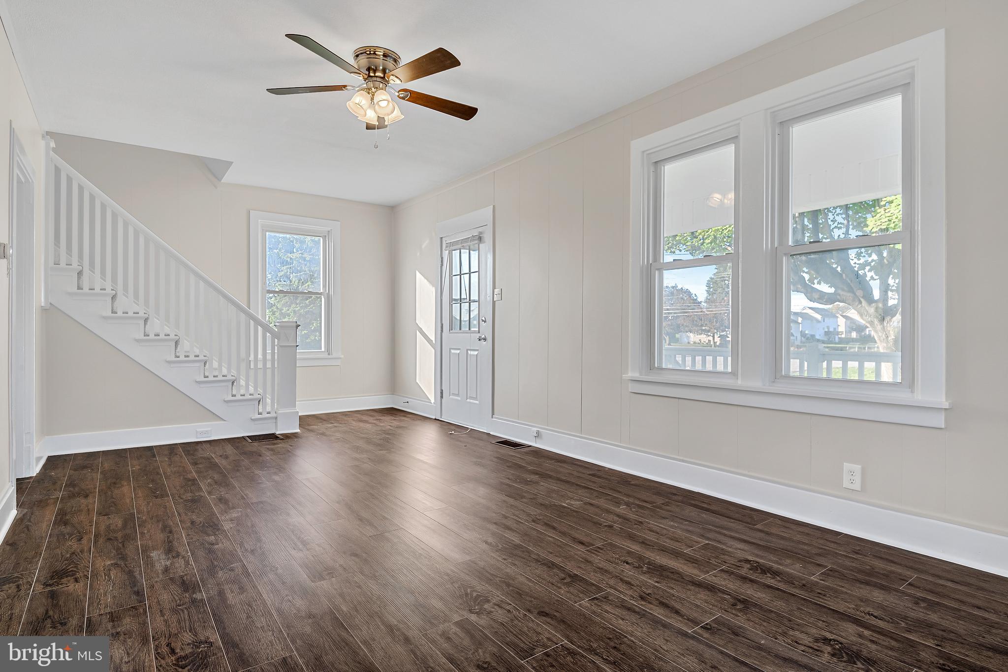 206 Hershey Road Hummelstown, PA 17036 - Photo 5 of 26 a view of an empty room with wooden floor and a window