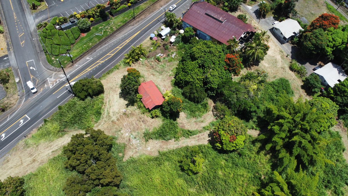82-6115 Hawaiʻi Belt Road Captain Cook, HI 96704 - Photo 4 of 9 an aerial view of a house with a yard and lake view