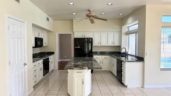 a kitchen with a stove a refrigerator and a sink