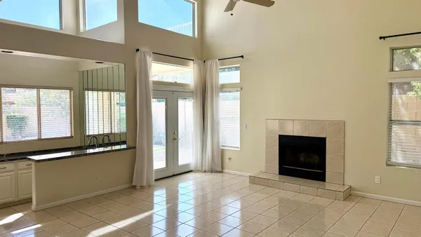a view of an empty room with a fireplace and a window