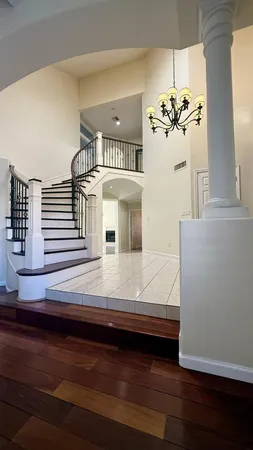 a view of living room with furniture and a chandelier