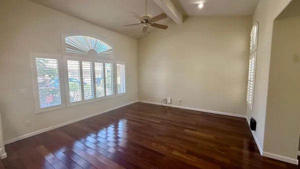 wooden floor in an empty room with a window