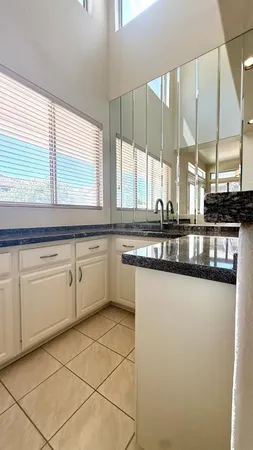a kitchen with stainless steel appliances granite countertop a sink and a stove