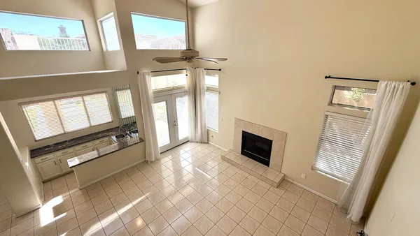 a view of an empty room with window and fireplace