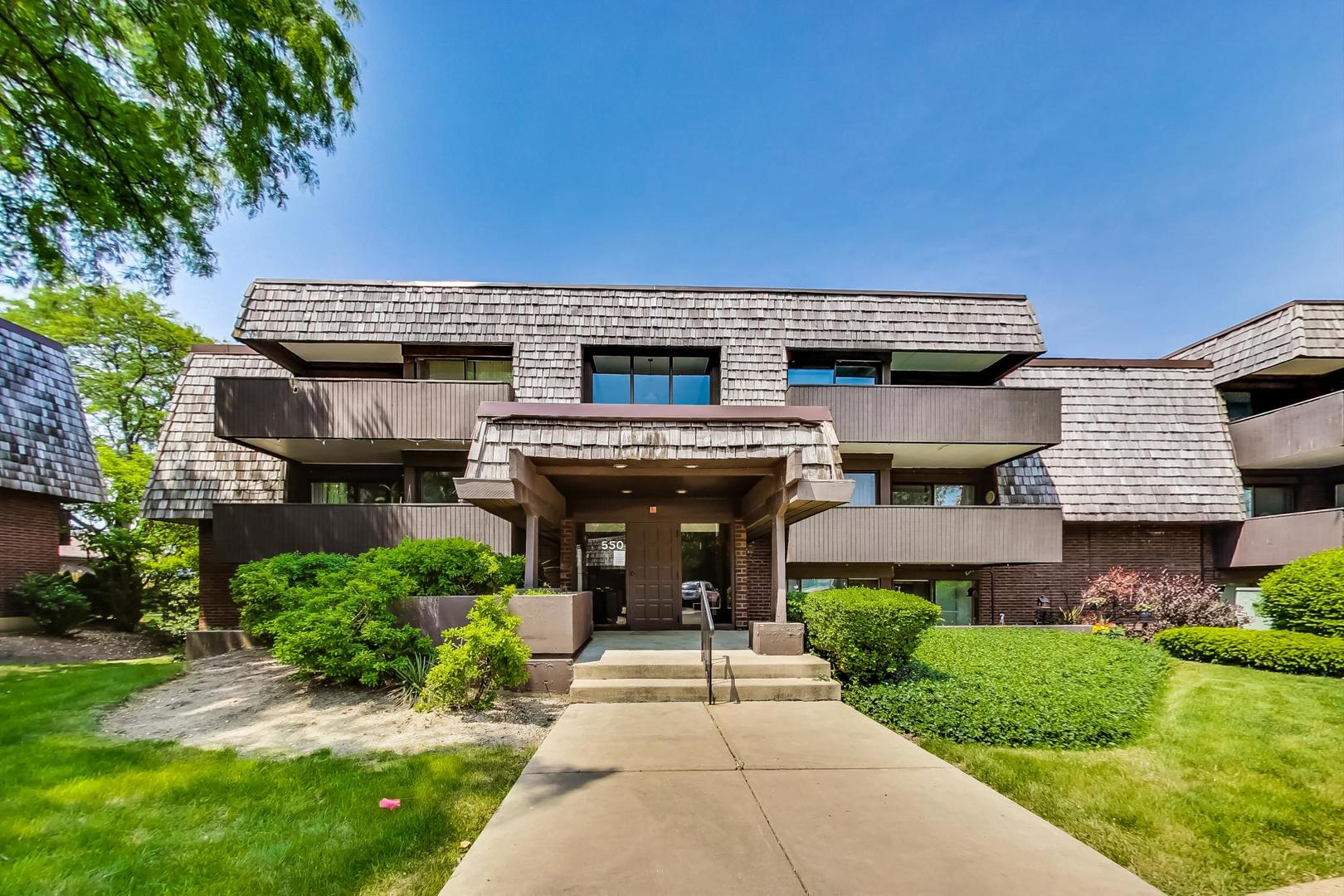 550 Timber Ridge Drive, Unit 304 Carol Stream, IL 60188 - Photo 1 of 22 front view of a house with a yard