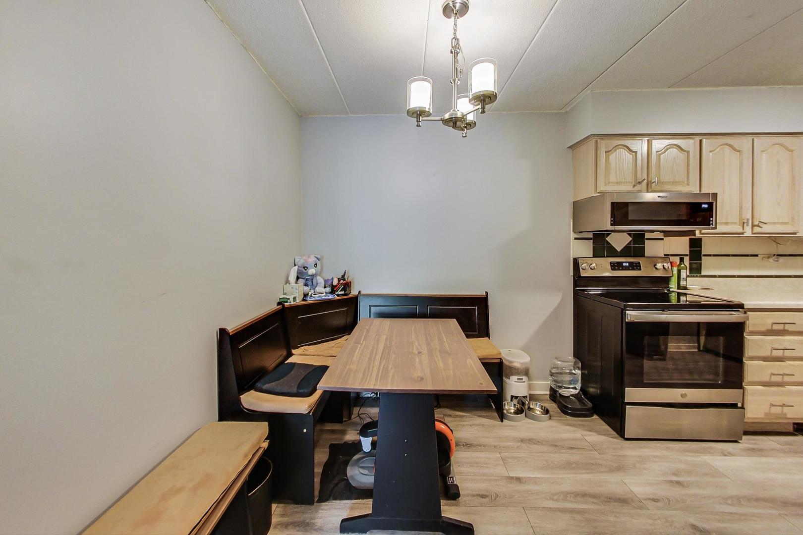 550 Timber Ridge Drive, Unit 304 Carol Stream, IL 60188 - Photo 11 of 22 a view of a dining room with furniture and wooden floor
