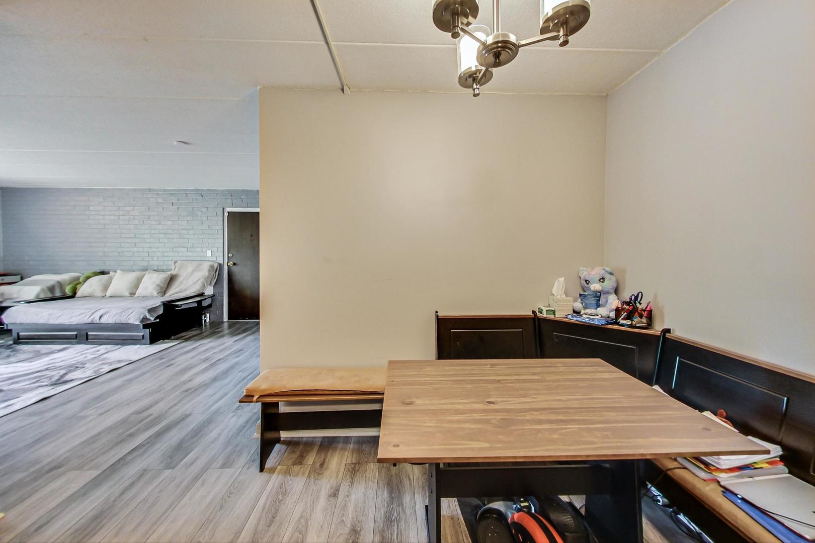 550 Timber Ridge Drive, Unit 304 Carol Stream, IL 60188 - Photo 12 of 22 a bedroom with a bed and wooden floor