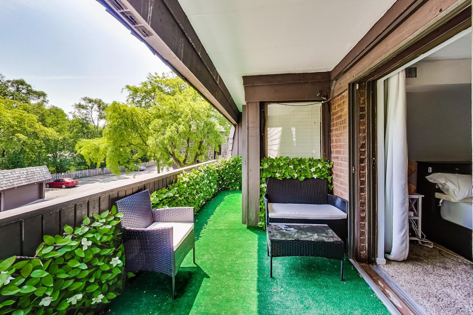 550 Timber Ridge Drive, Unit 304 Carol Stream, IL 60188 - Photo 16 of 22 a view of a chair and table in the balcony