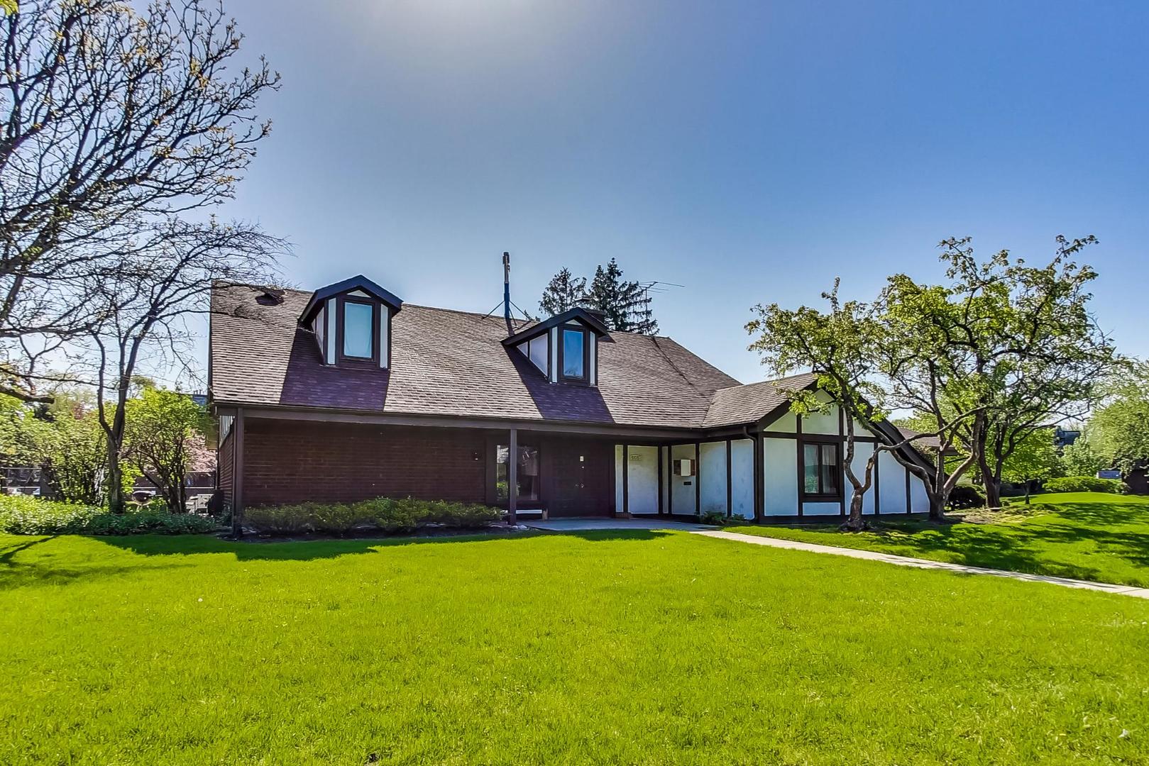 550 Timber Ridge Drive, Unit 304 Carol Stream, IL 60188 - Photo 18 of 22 a front view of a house with garden