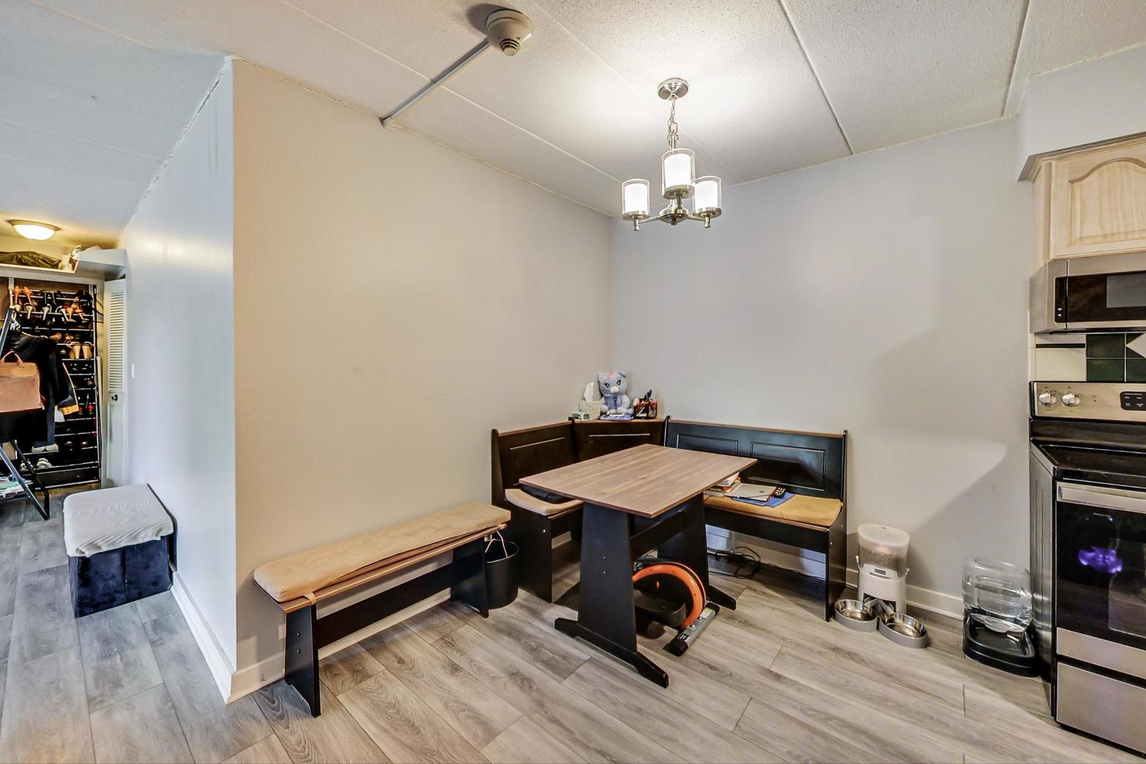 550 Timber Ridge Drive, Unit 304 Carol Stream, IL 60188 - Photo 9 of 22 a bedroom with furniture and a wooden floor