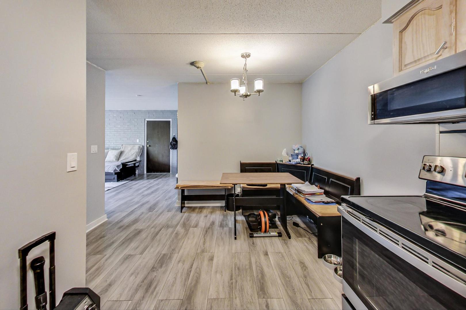 550 Timber Ridge Drive, Unit 304 Carol Stream, IL 60188 - Photo 10 of 22 a room with wooden floor and furniture