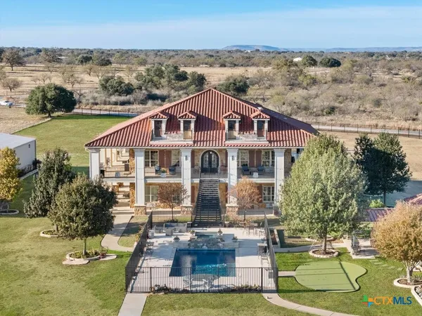 an aerial view of a residential houses with outdoor space