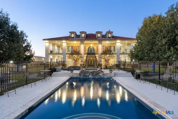 a spacious bathroom with a shower a sink and a mirror