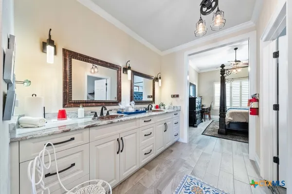 a large kitchen with stainless steel appliances a large counter top a stove and a refrigerator