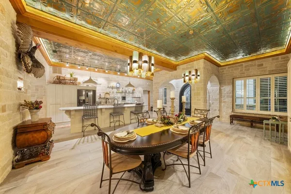 a view of a tables and chairs in patio of the house