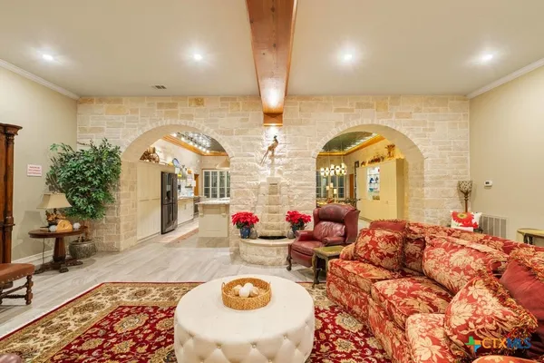 an aerial view of a house with a garden and lake view