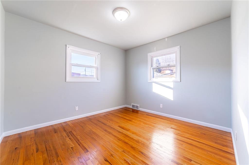 708 Middle 1st Street Rural Valley, PA 16249 - Photo 14 of 22 an empty room with wooden floor and windows