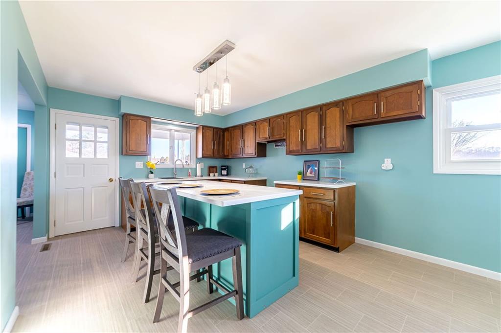 708 Middle 1st Street Rural Valley, PA 16249 - Photo 8 of 22 a kitchen with a table chairs refrigerator and cabinets