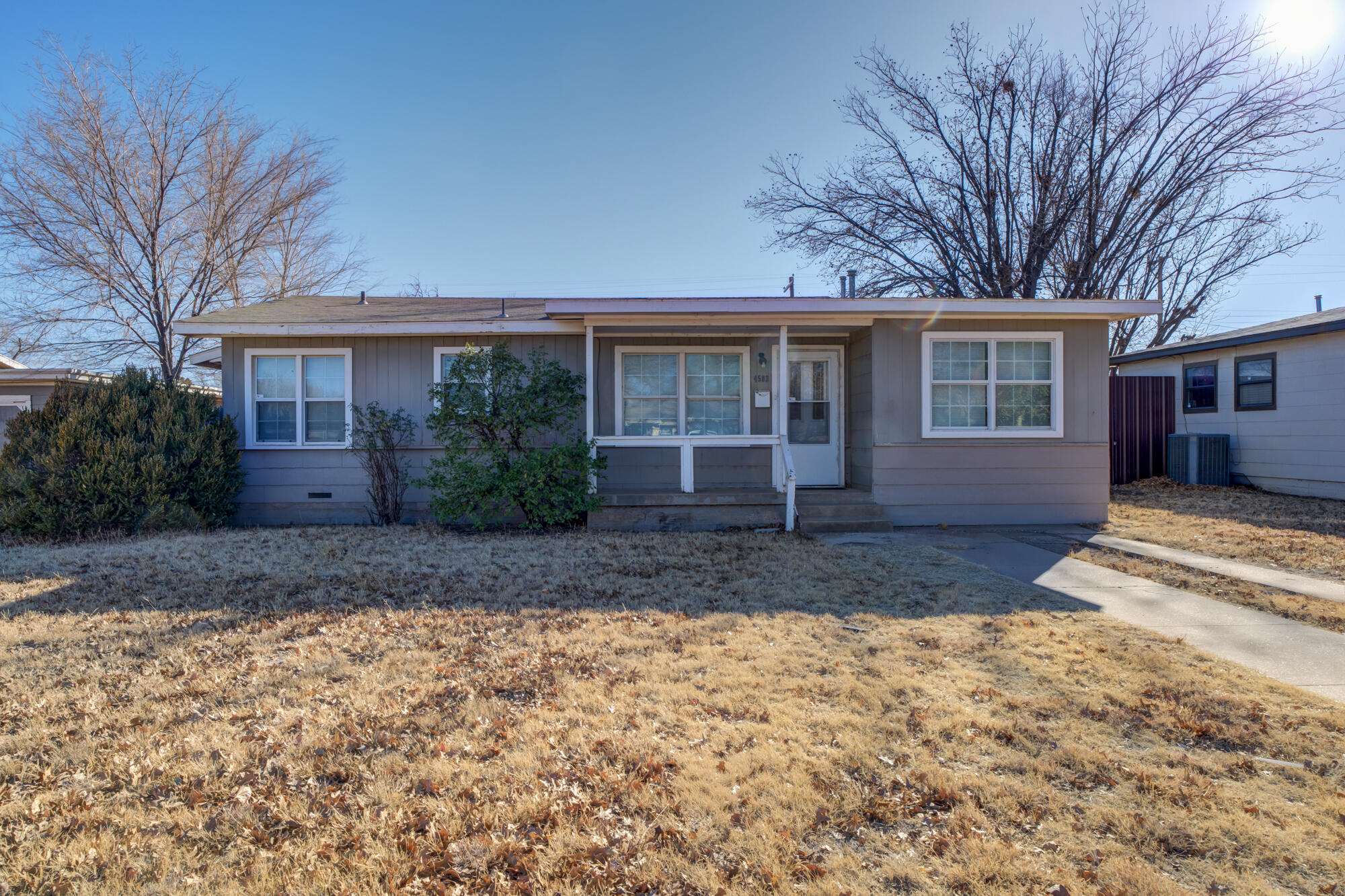 4503 45th Street Lubbock, TX 79414 - Photo 1 of 27 a view of a house with a yard and large tree