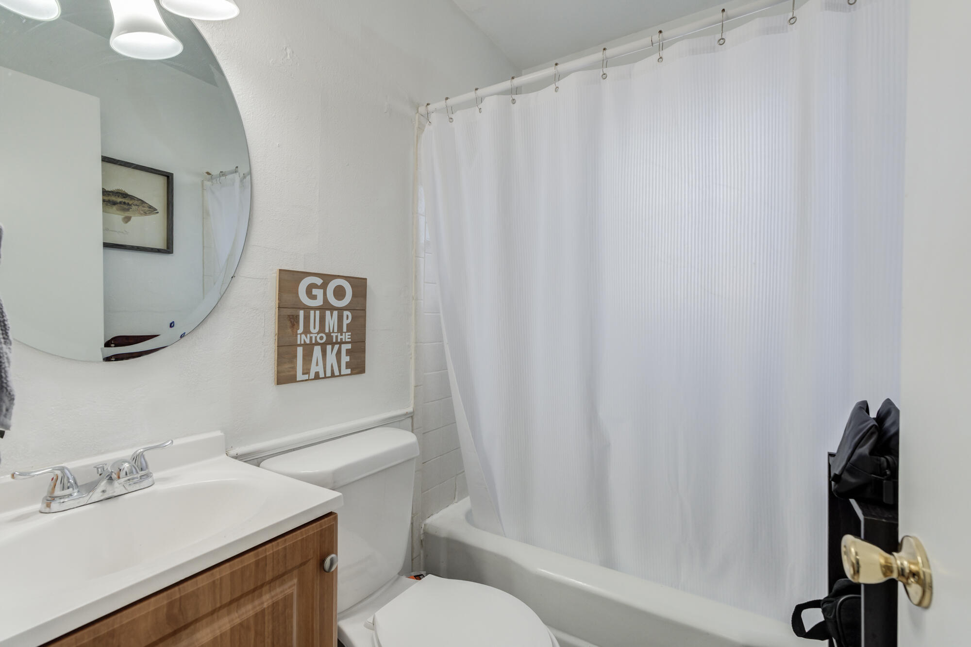 4503 45th Street Lubbock, TX 79414 - Photo 17 of 27 a bathroom with a sink toilet and vanity