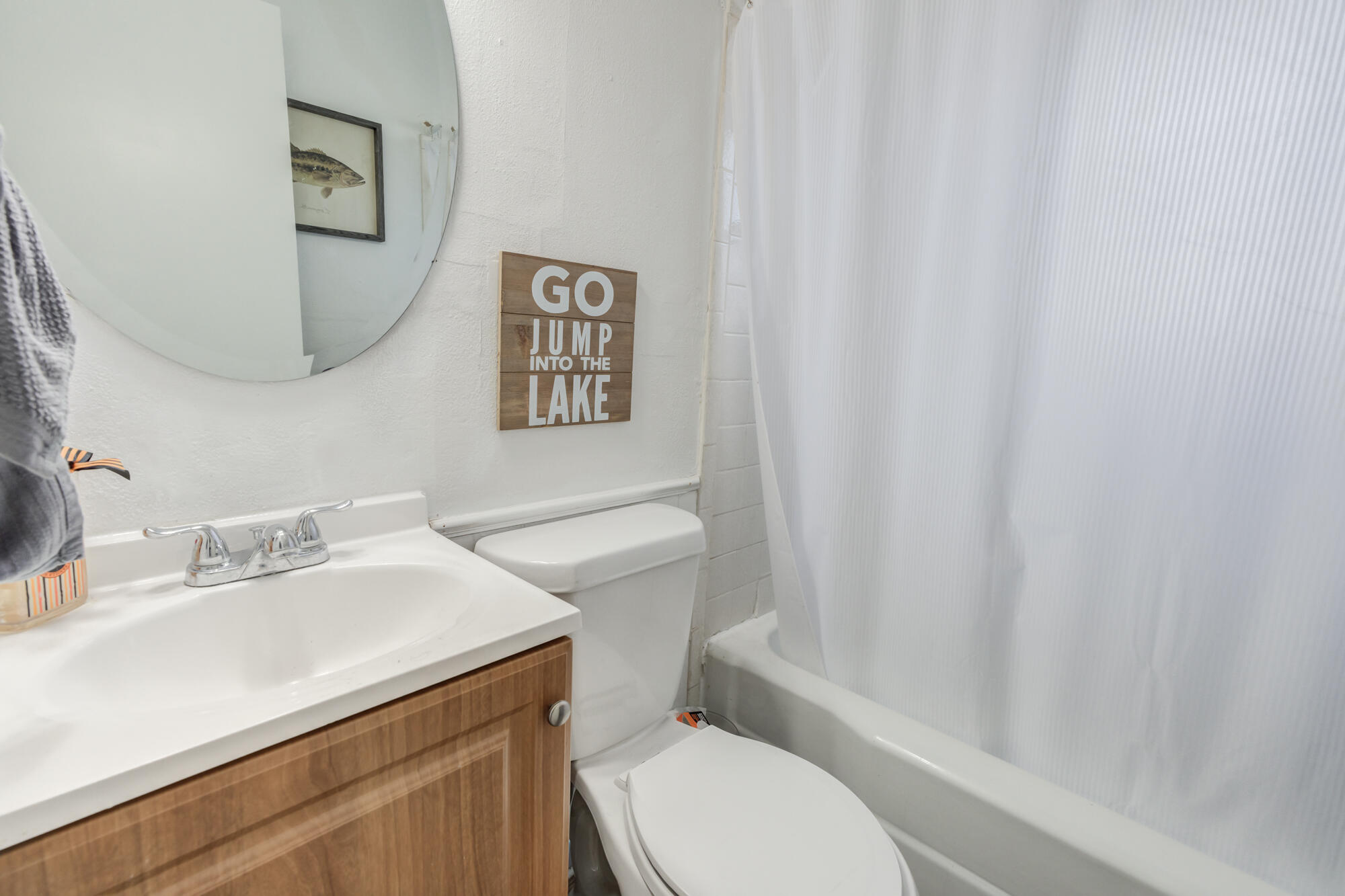 4503 45th Street Lubbock, TX 79414 - Photo 18 of 27 a white toilet sitting next to a bathroom sink