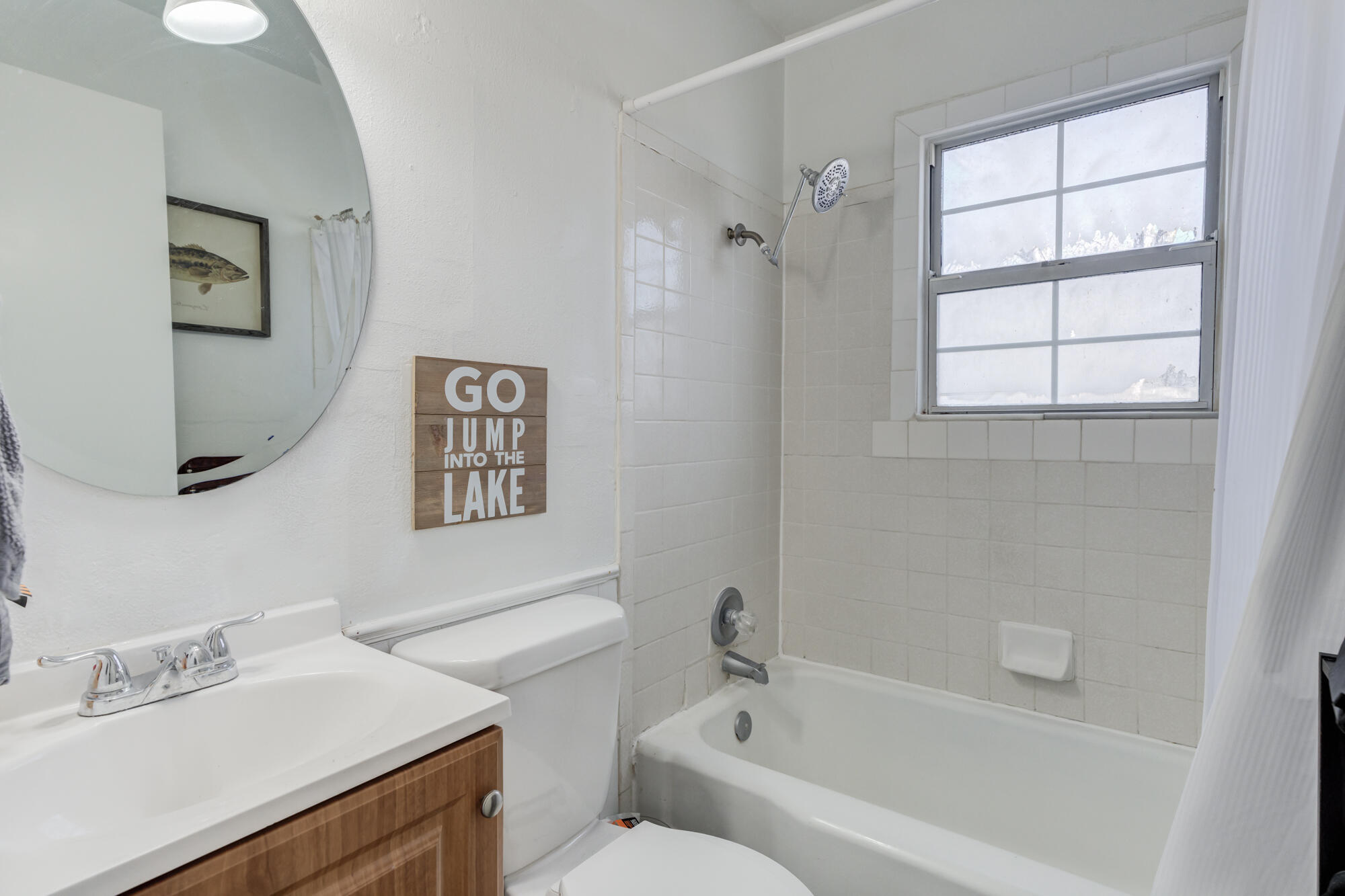 4503 45th Street Lubbock, TX 79414 - Photo 19 of 27 a white bath tub sitting next to a white sink and a toilet