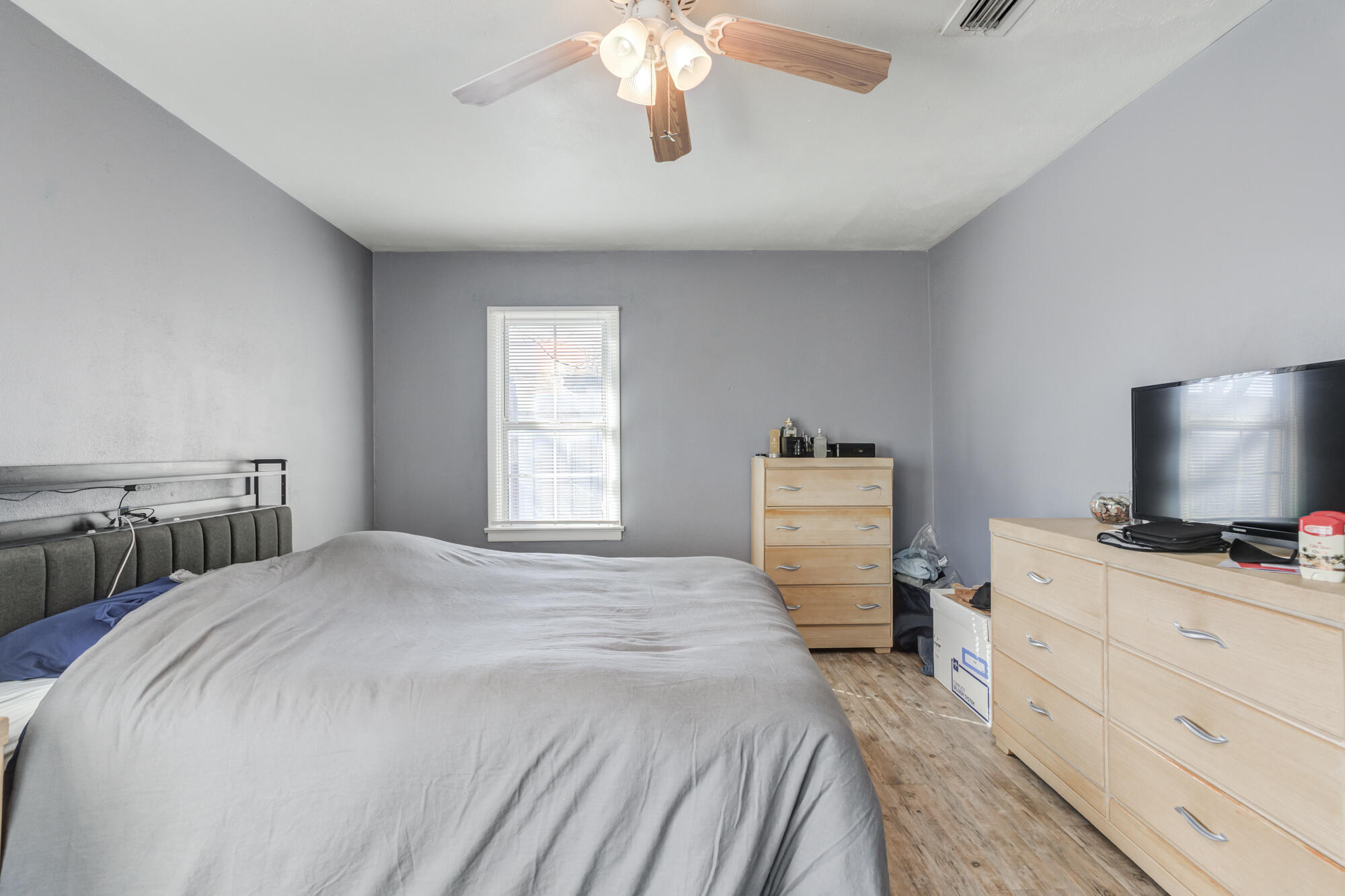 4503 45th Street Lubbock, TX 79414 - Photo 23 of 27 a bedroom with a bed and a flat screen tv