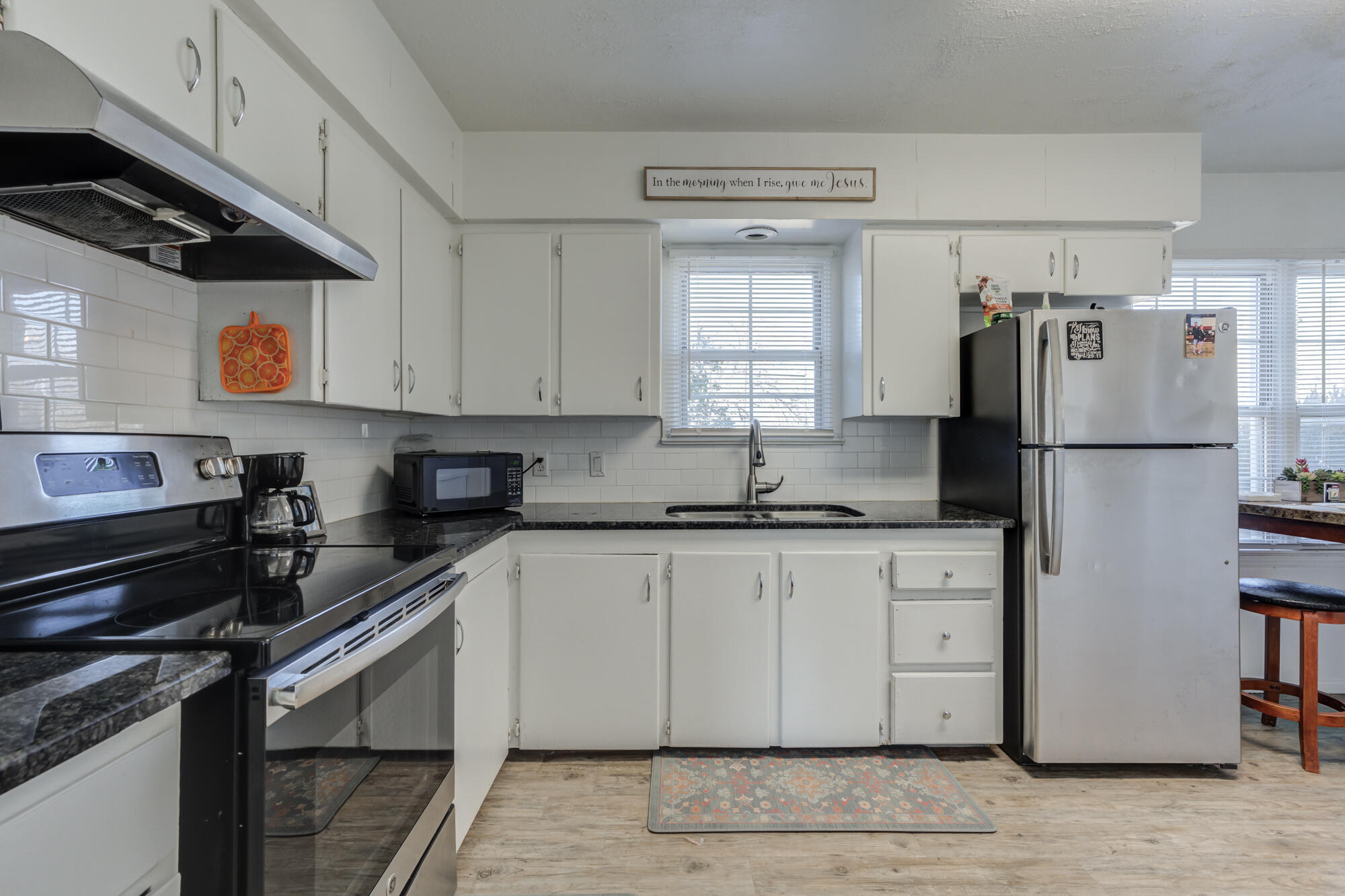 4503 45th Street Lubbock, TX 79414 - Photo 7 of 27 a kitchen with stainless steel appliances granite countertop a refrigerator a sink and a stove