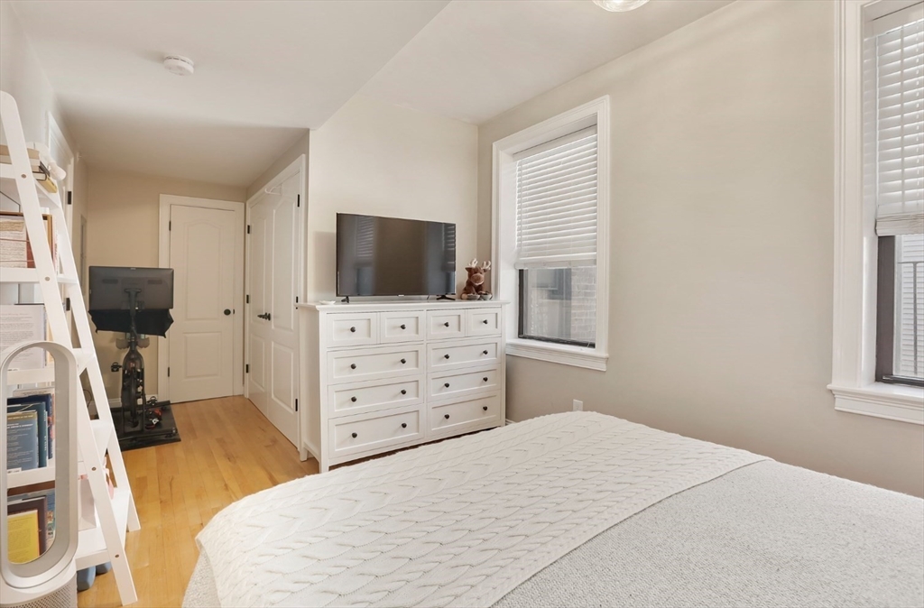 454 Hanover Street, Unit 4 Boston, MA 02113 - Photo 12 of 23 a bedroom with a bed and flat screen tv