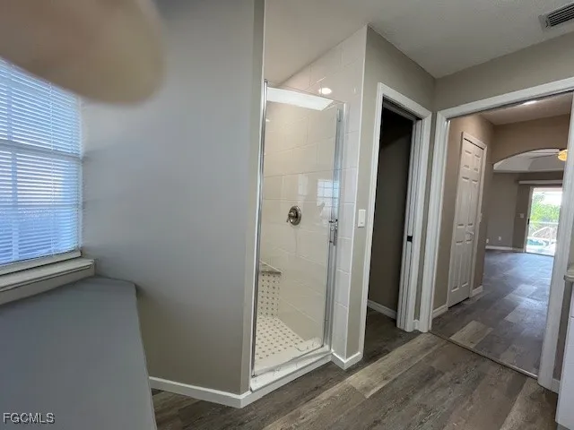 a large bathroom with a large window sink and mirror