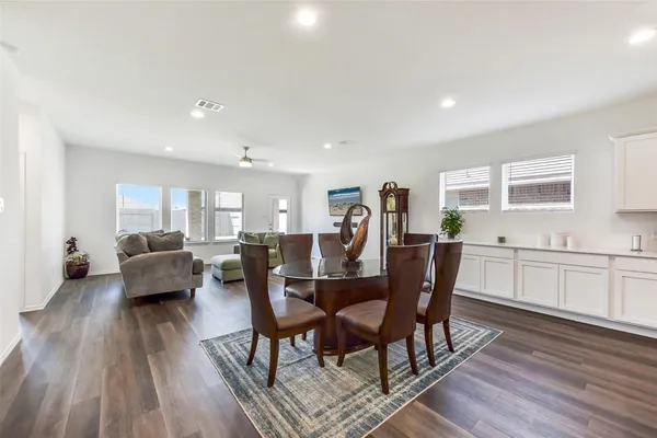 a view of a dining room with furniture and wooden floor