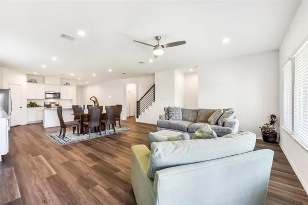 a living room with furniture and kitchen view