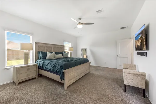 a bedroom with a bed and a flat screen tv