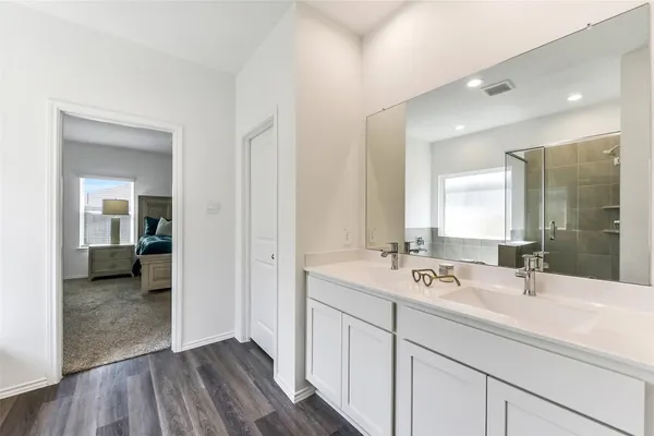 a bathroom with a sink a mirror and a bathtub