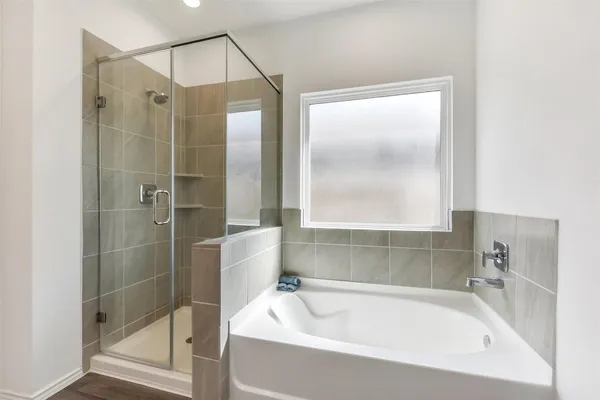 a bathroom with a bathtub and a shower