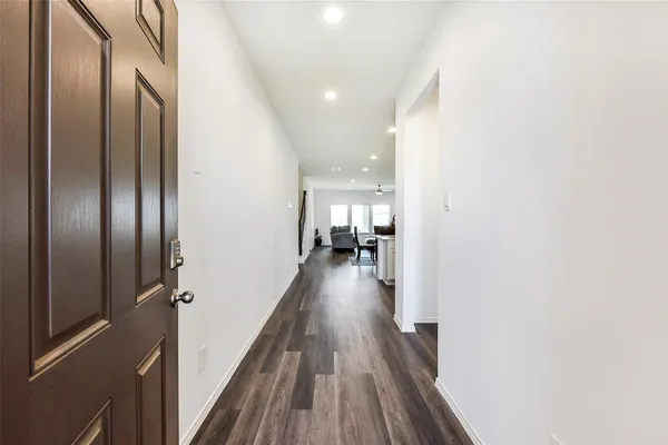 a view of hallway with wooden floor