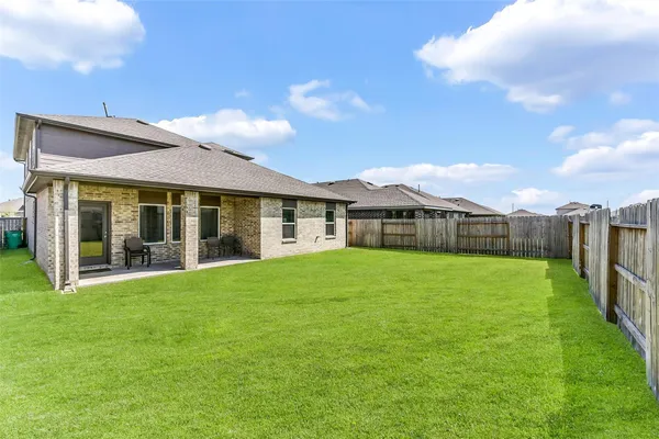 a view of an house with backyard space and balcony
