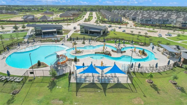a view of a swimming pool with outdoor seating