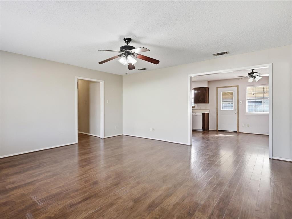 701 College Street Celeste, TX 75423 - Photo 4 of 29 a view of an empty room with window and wooden floor