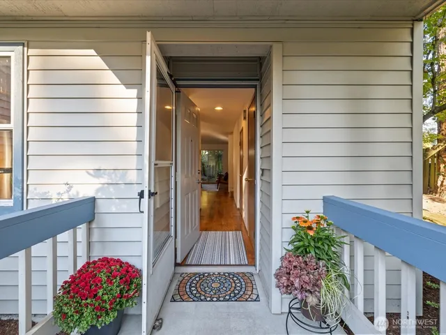 a view of a house with brick walls and flower plants