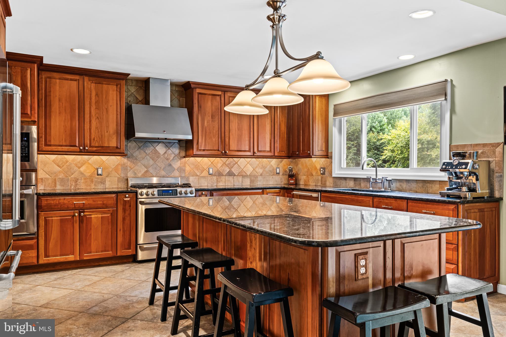 20 Highfield Court Cockeysville, MD 21030 - Photo 23 of 60 a kitchen with stainless steel appliances granite countertop a stove a sink and a wooden cabinets