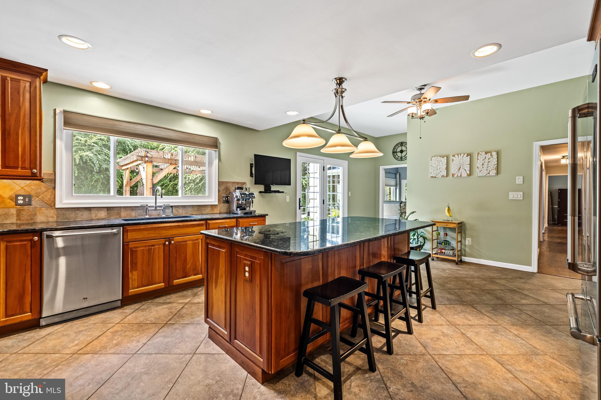 20 Highfield Court Cockeysville, MD 21030 - Photo 26 of 60 a kitchen with stainless steel appliances granite countertop a stove a refrigerator a sink dishwasher with a dining table and chairs