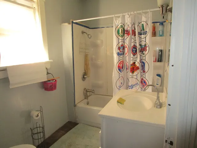 a utility room with refrigerator and toys