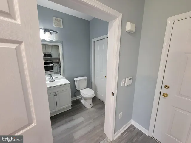 a bathroom with a toilet sink and mirror